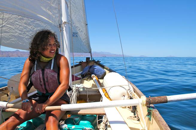 A student uses oars while out on a sailboat in Baja California, Mexico.