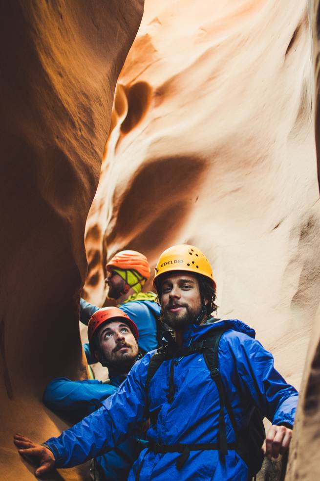 Students pause while canyoneering through a chimney.