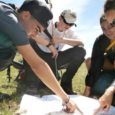 Students work with an instructor to determine their location on a map.