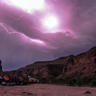 A lightning storm lights up the sky after a rewarding day of kayaking in the canyons.