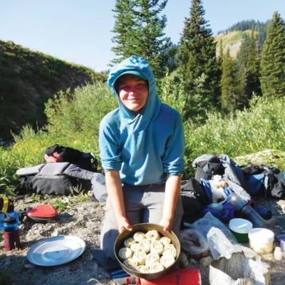 A student shows off the cinnamon rolls made on her course.