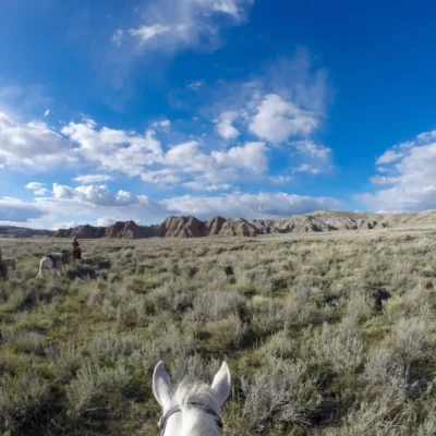 Students on horseback traveling through the plains of Wyoming.