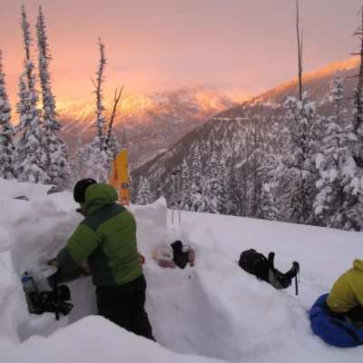 As the sun sets over the snowy hills of the Teton Valley backcountry, one student begins to prep dinner in the kitchen while another manages their gear from the day.