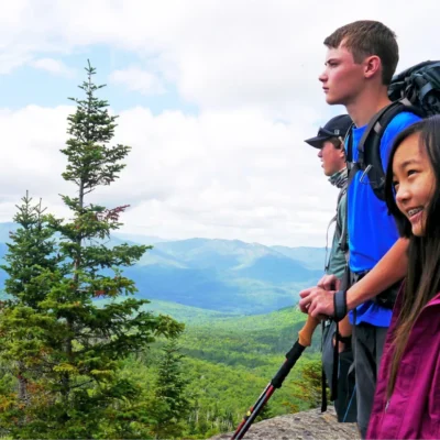 Students take in a sweeping view after summiting a peak in the Adirondacks.