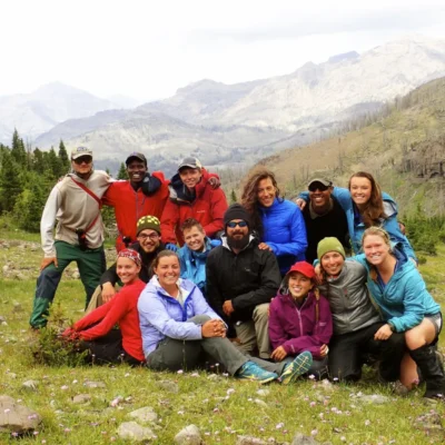 A course smiles while posing for a photo together in Wyoming's Absaroka-Beartooth Wilderness Wilderness.