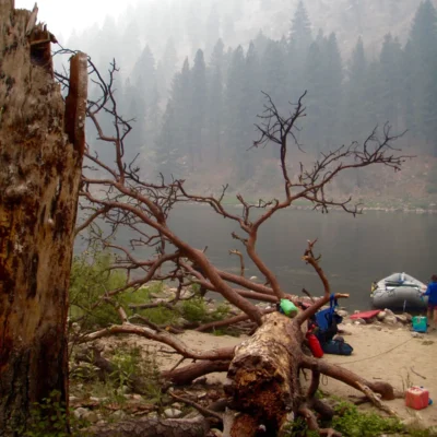 Students dock their rafts for a break in a misty canyon.