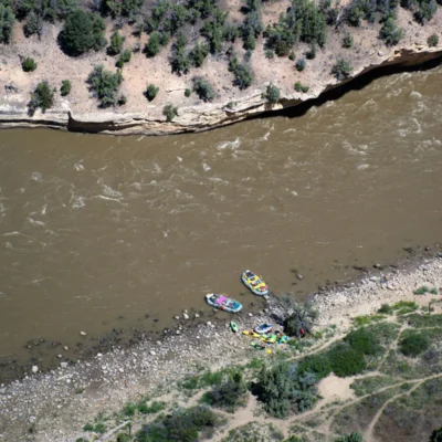 Aerial view of students rafting on the white water.