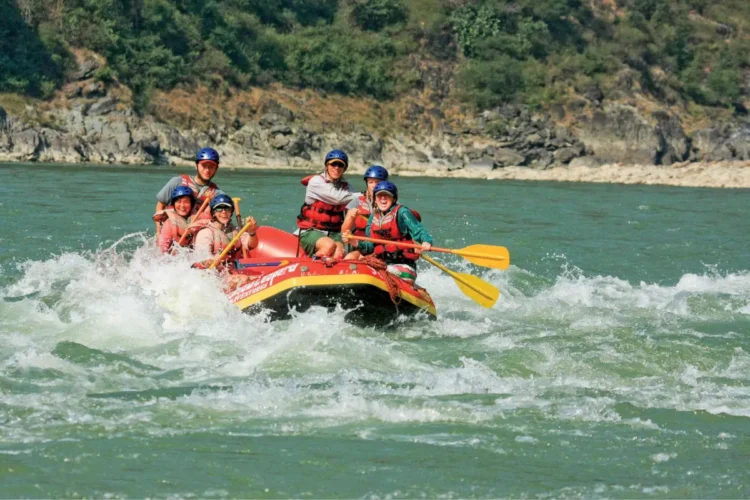 Students have fun in the rapids while whitewater rafting in India.