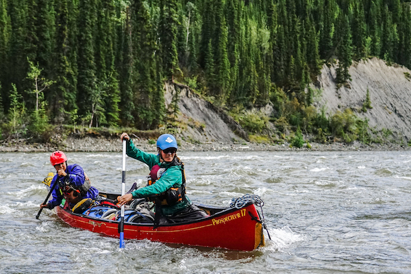 NOLS summer semester participants paddle a whitewater canoe in the Yukon