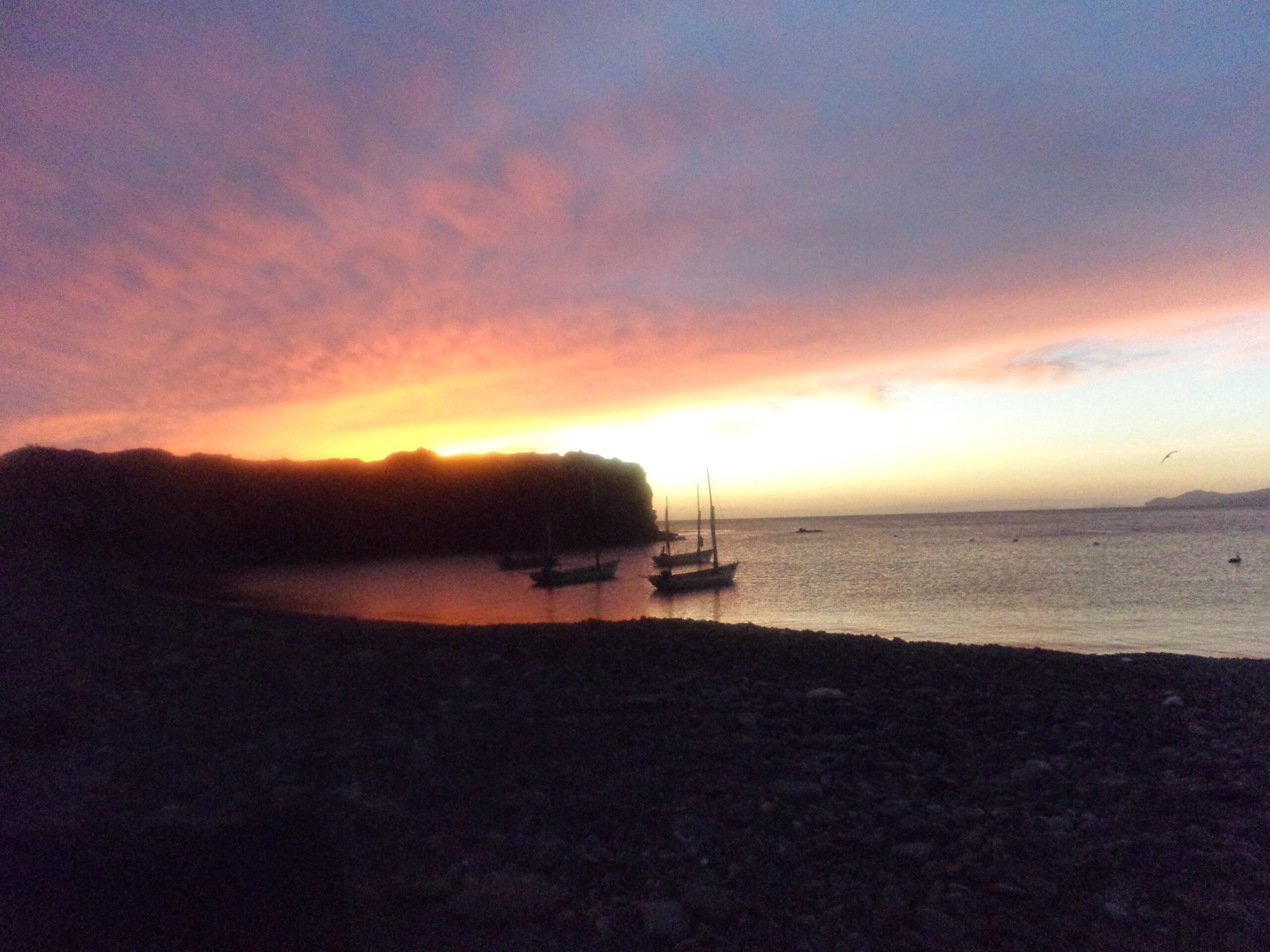 Sunset on Baja coast with sailboats
