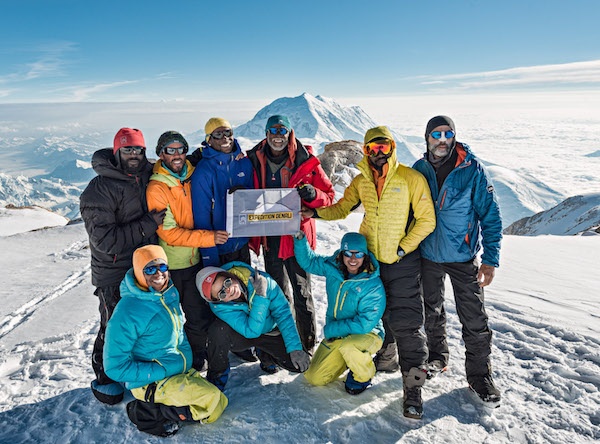 Expedition Denali team poses for a group photo on the snowy slopes of Denali