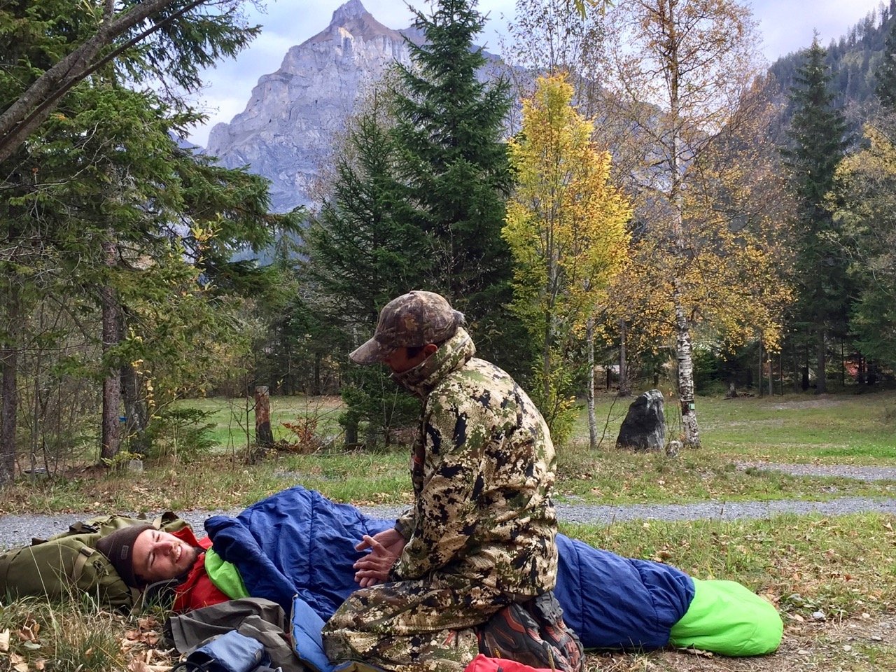 NOLS Wilderness Medicine student practices caring for a patient wrapped in a sleeping bag in the mountains