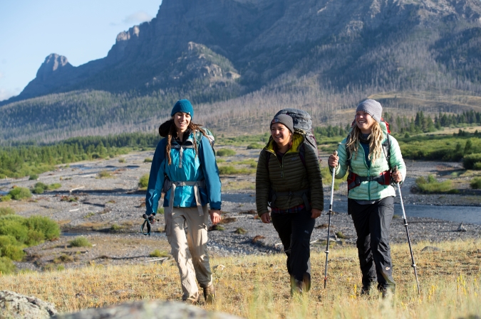 3 gap year students hiking with mountains behind them