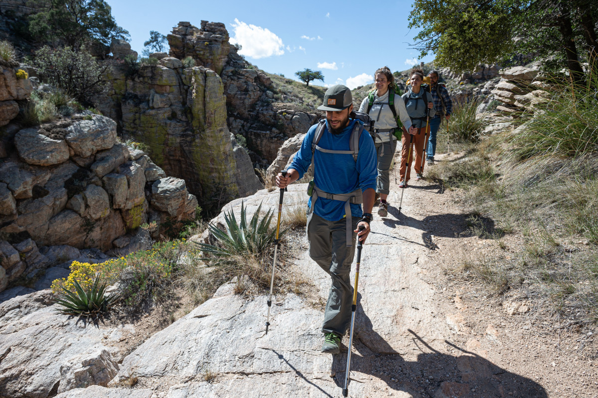 Three backpackers in the desert