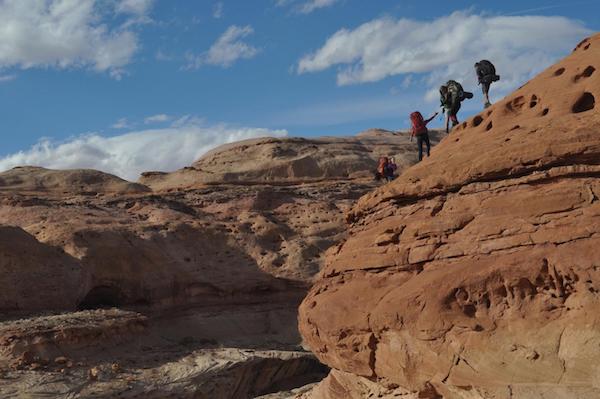 four NOLS students hiking in the Utah Canyonlands