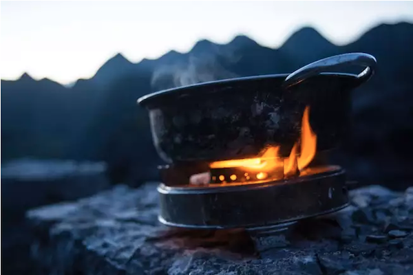 heating water to make a freezer bag meal while backpacking
