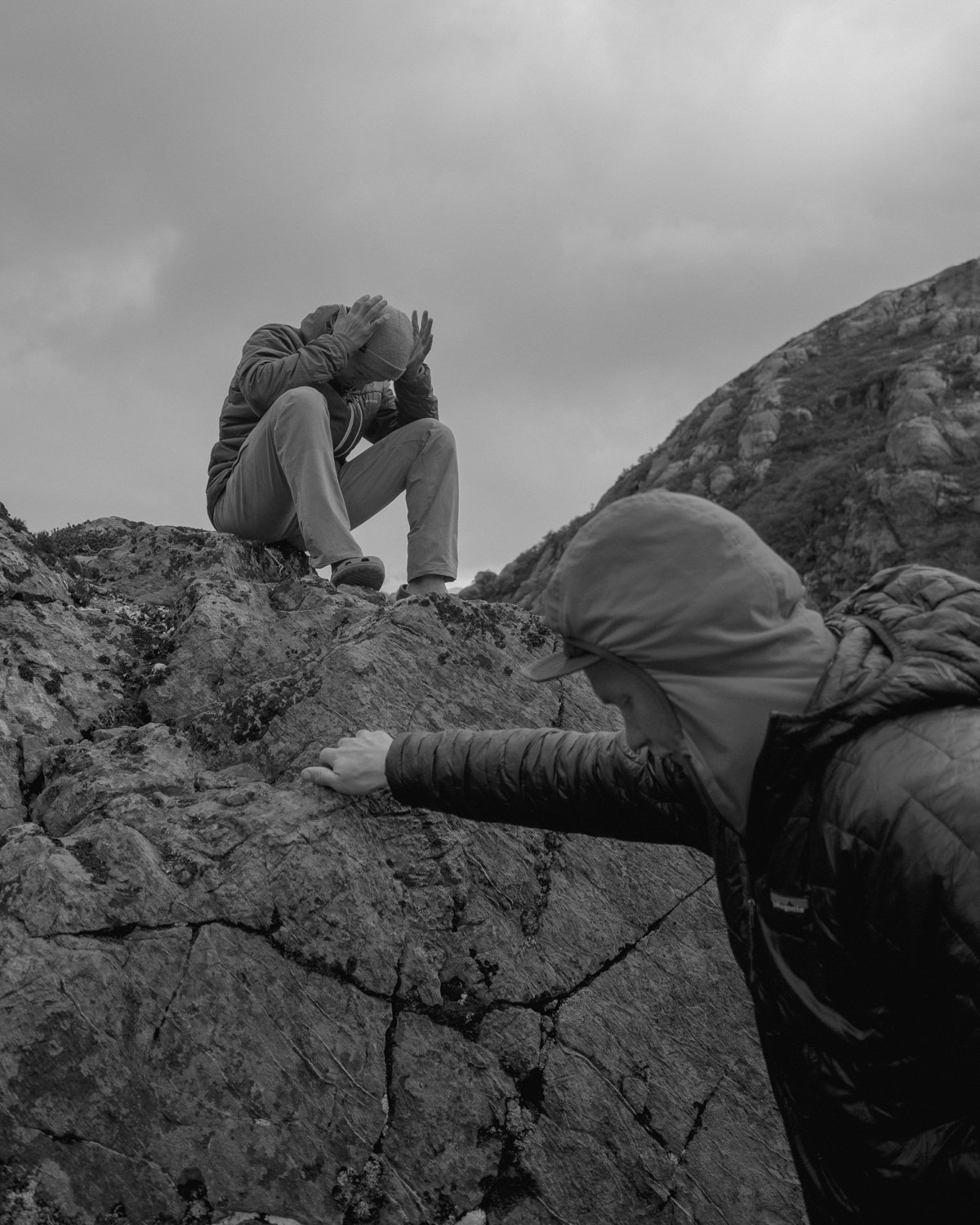 People looking thoughtful sitting on rocks