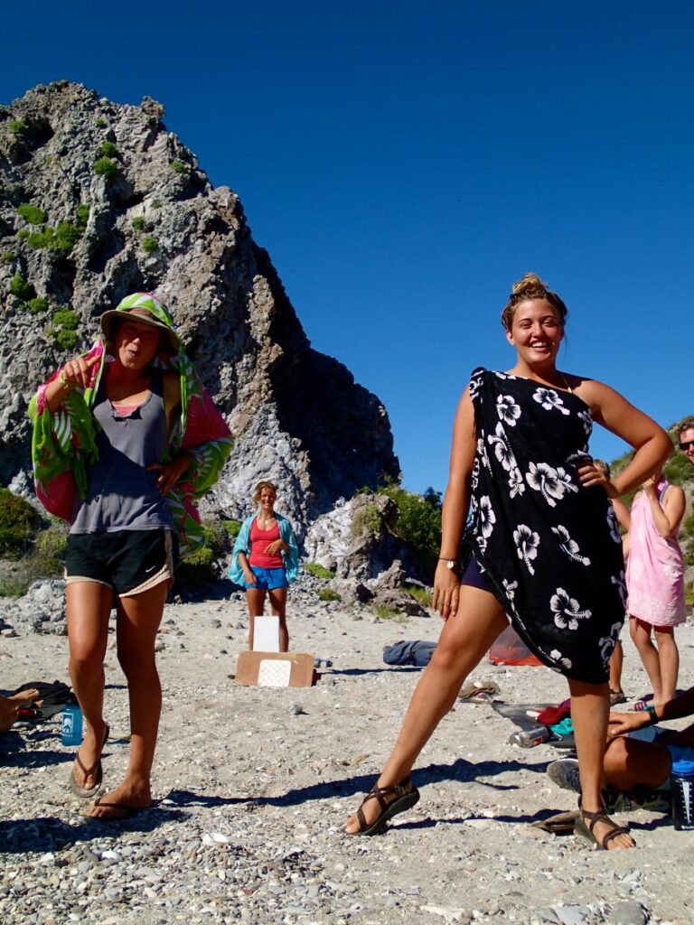 Sarong tying class and runway walk off on the beach at San Basilio anchorage. Alyssa Taylor, Rita Slanina, Alisha Bube
