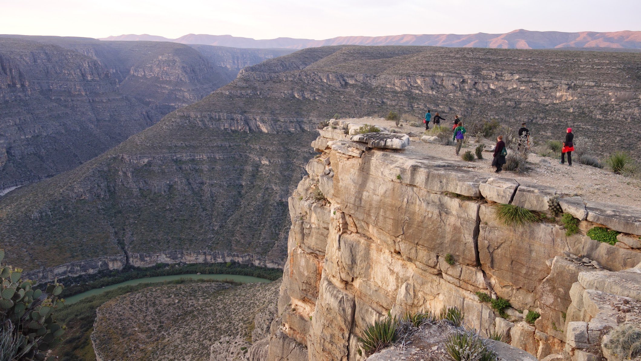 People on a high cliff overlooking the Rio Grande