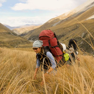 Students hiking uphill through tall grass on New Zealand's South Island. Credit: Fredrik Norrsell