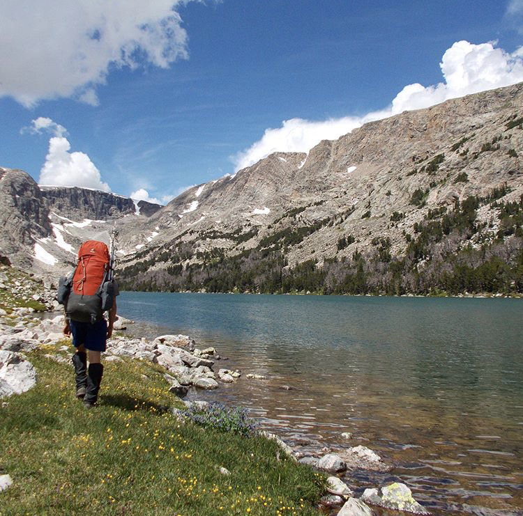 Backpacker along a lake in the Wind River Range
