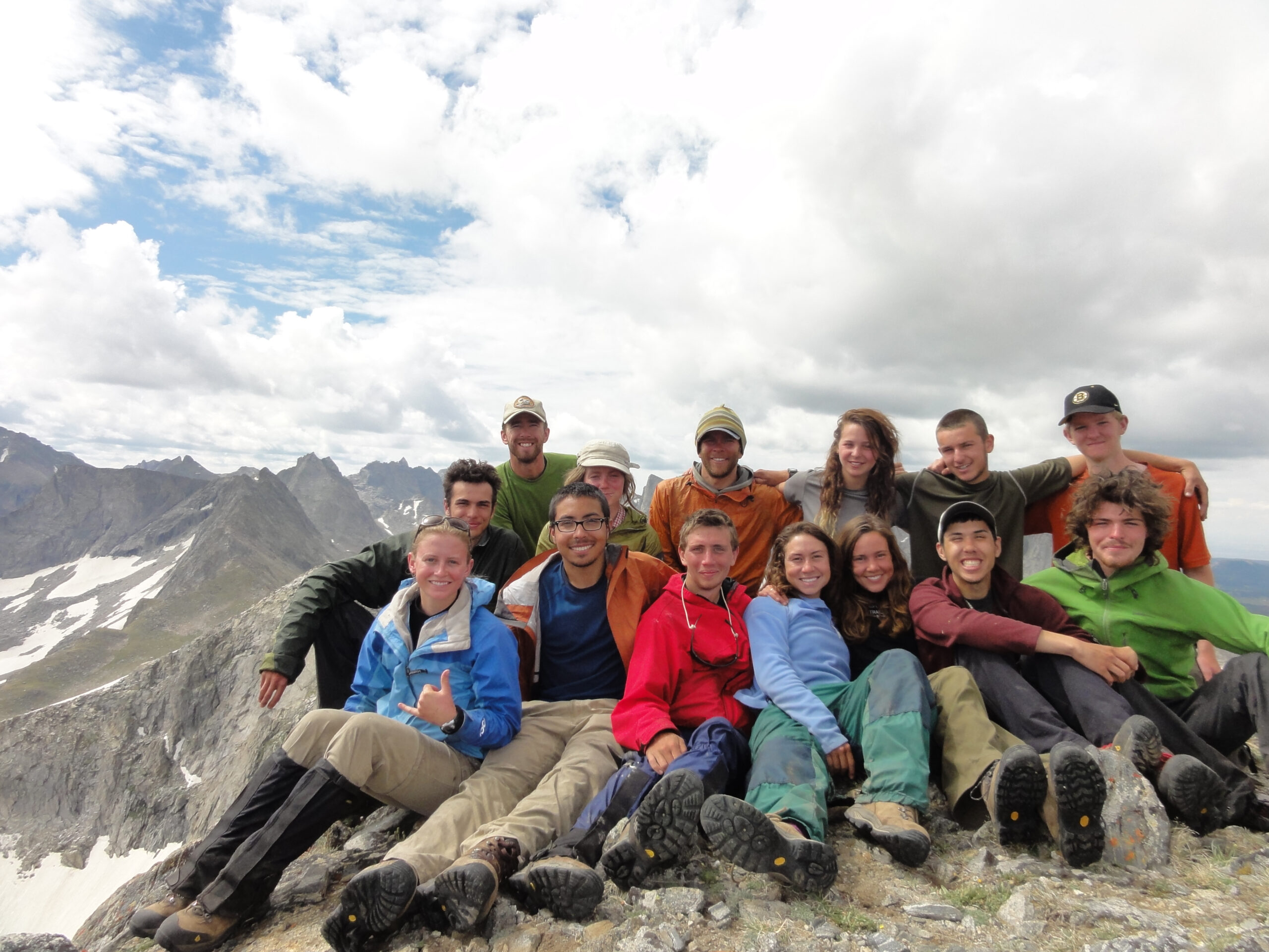 Course: ROCL 6.25, NOLS RM"Rock City" celebrates on top of Kagevah Peak.Subjects:Back row (R to L): Zev Underwood, Herb Crimp, Genevieve Bartlam, Evan Miller, Halley Steiner, Brendan Coyne, Charles StoutFront row (R to L): Kyle Cassling, Aidan Clawson, Brady Butler, Liz Mesa, Ali Dulchausky, Johnathan Rigby, Jed Doohan rocky