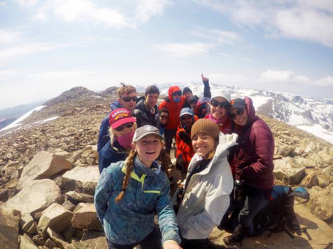Students celebrate summiting a peak in the Wind River Range.