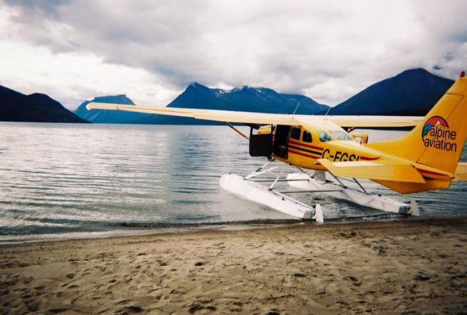 A float plane parked along the shore brings re-ration food and supplies to a course backpacking in the Yukon.