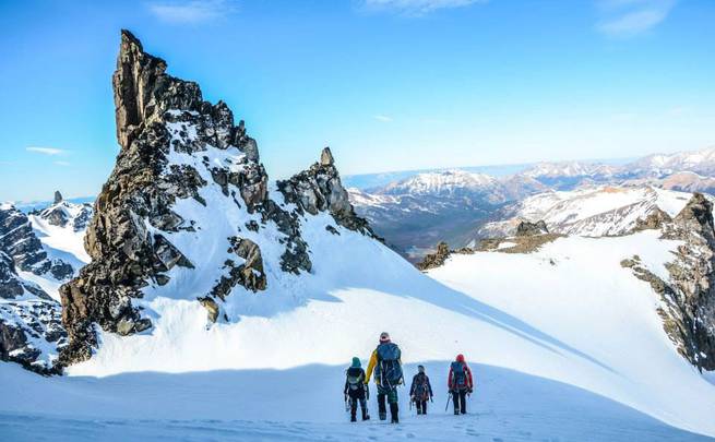 Students take in a sweeping view while mountaineering past craggy spires in Patagonia.