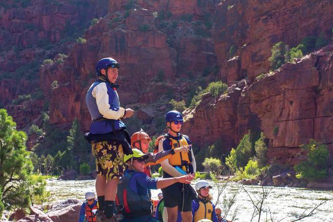 Students discussing route planning strategies for the whitewater ahead