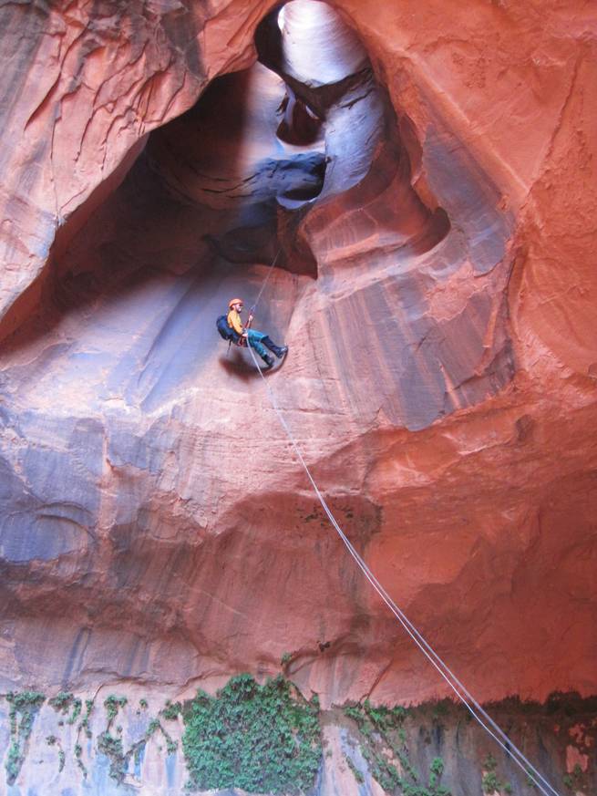A student rappelling down the spectacular Golden Cathedral in Neon Canyon.