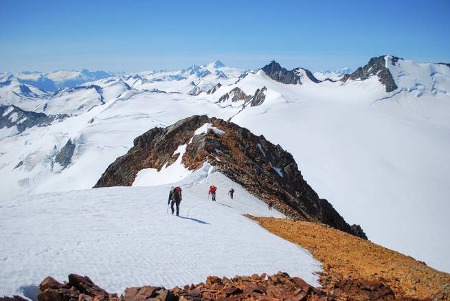 A rope team ascends St. John in the Waddington Range.