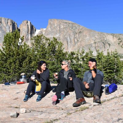 Course participants laugh together while relaxing in camp.