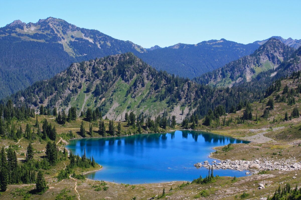 Cobalt-blue lake, called Lunch Lake, surrounded mountains and pines in Olympic National Park