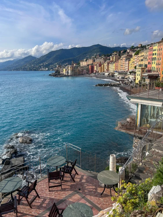 Colorful buildings line the coast with mountains and ocean surrounding them.