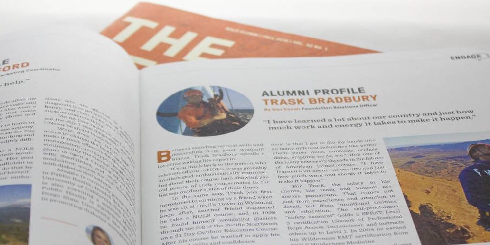 The Leader magazine laying open to a page on alumni profiles.