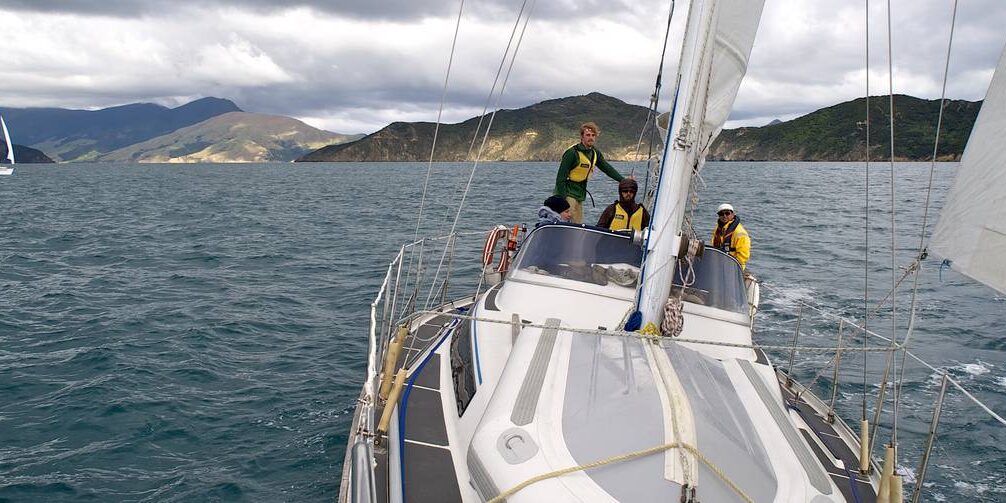Students out sailing a 35 to 40-foot keelboat on the Marlborough Sound in New Zealand.
